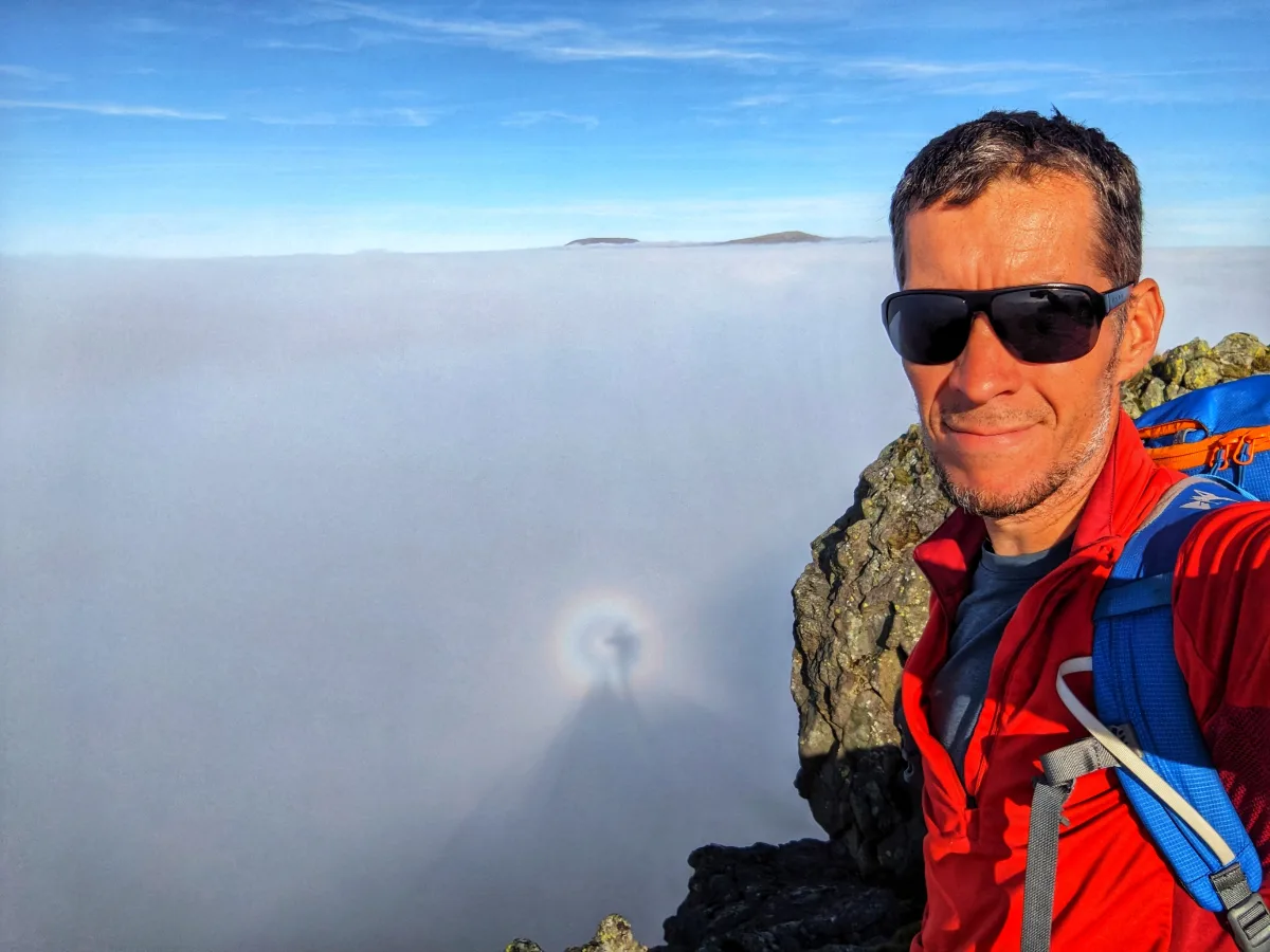 Simon on a summit above the clouds