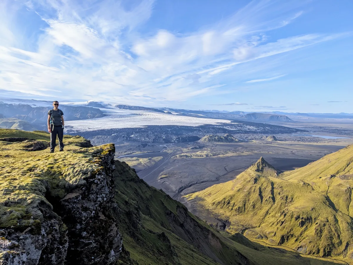 Simon overlooking a glacier and mountain valley in Iceland